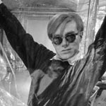 Andy and Gerard Malanga working on a large flower painting, the Factory, NYC, spring 1965